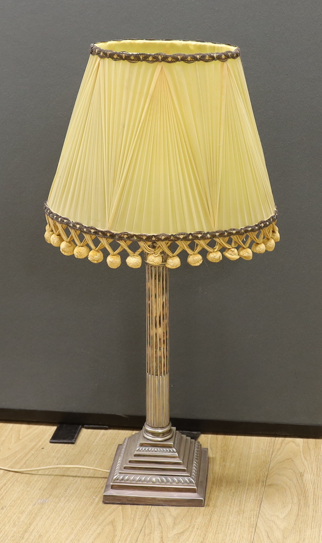 A tall silver plated Corinthian column desk lamp with shade, 75cm total